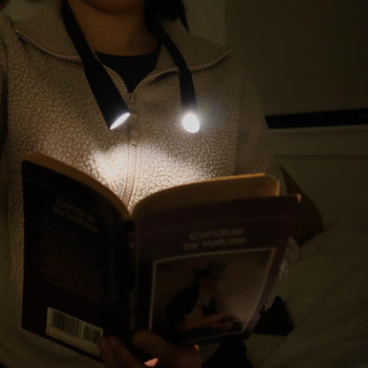 front view of person reading using the flexible neck lamp.
