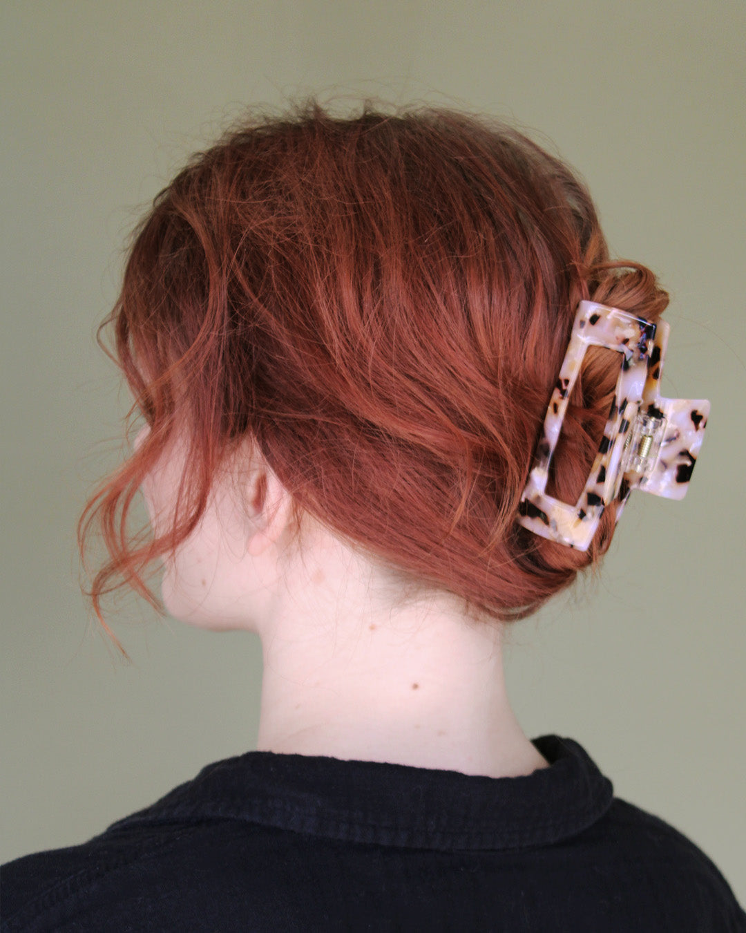 person with red hair clipped in a claw clip.