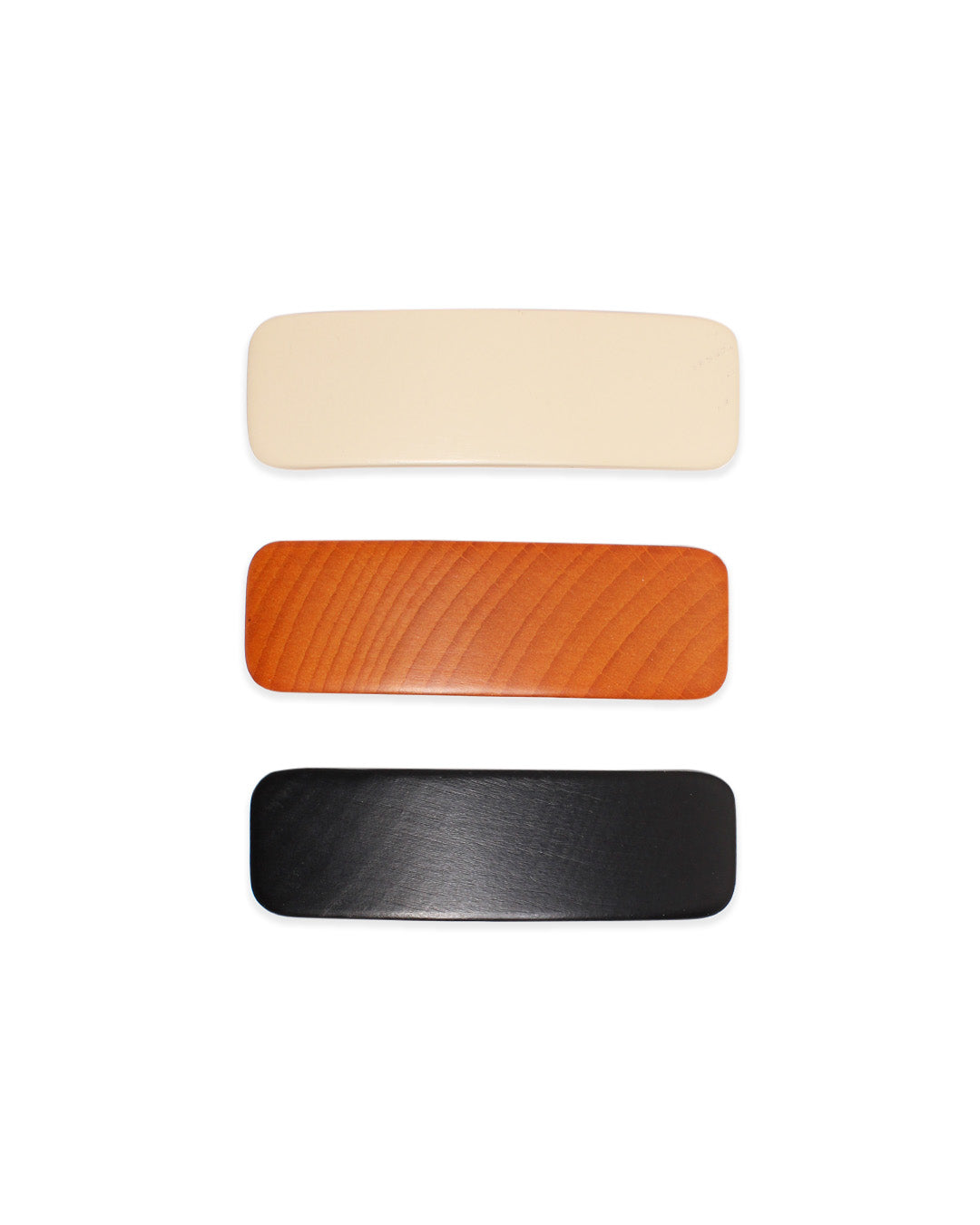 3 colors of wooden barrettes on a white background.