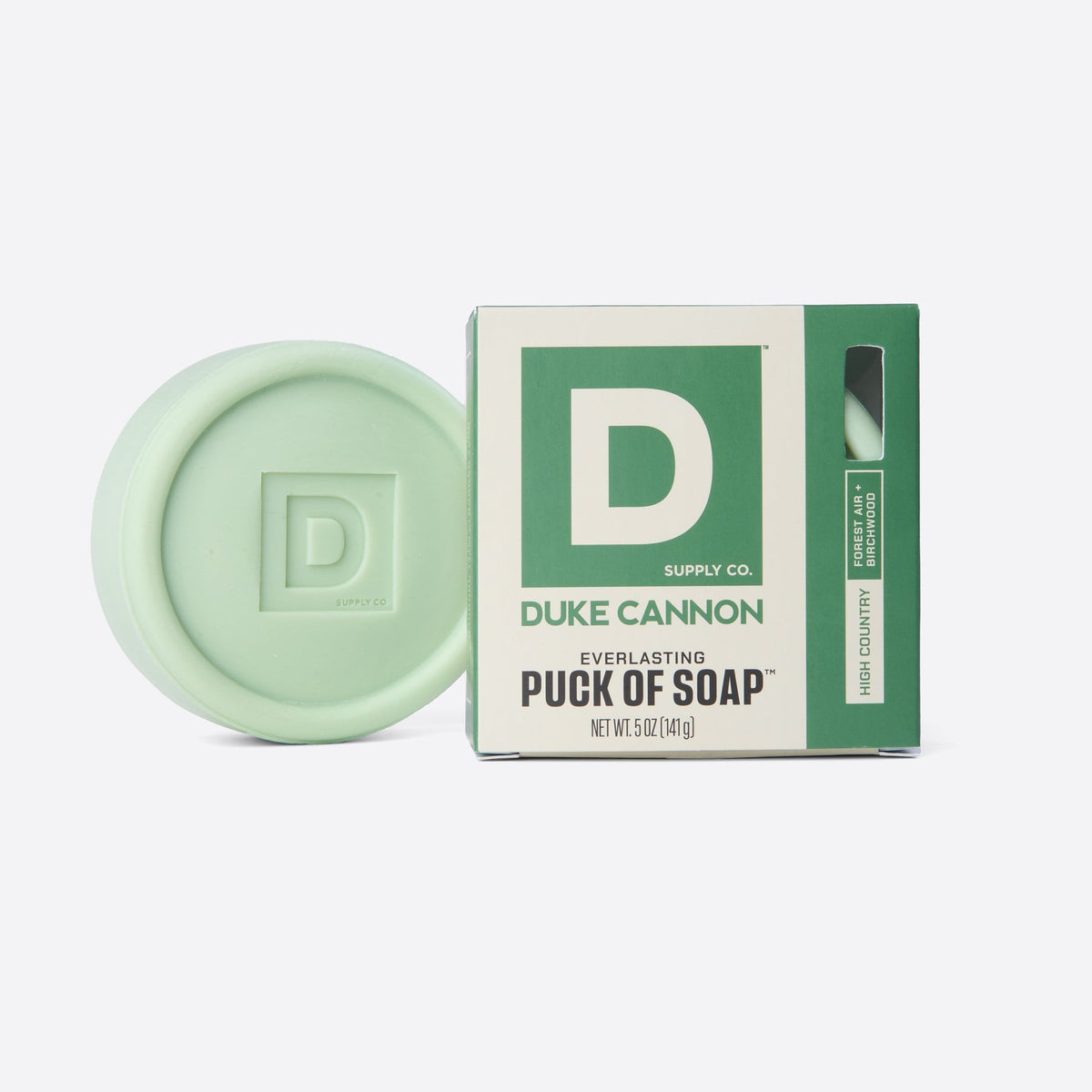 high country scent soap puck next to its box on a white background