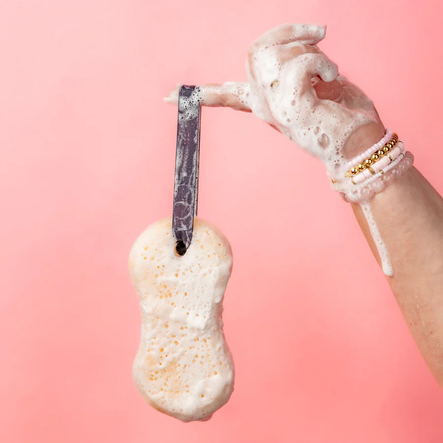 hand holding soapy Sweet Grace Body Wash Soap Sponge by it loop handle