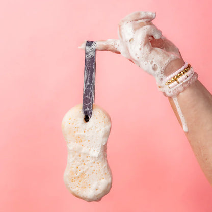 hand holding soapy Sweet Grace Body Wash Soap Sponge by it loop handle