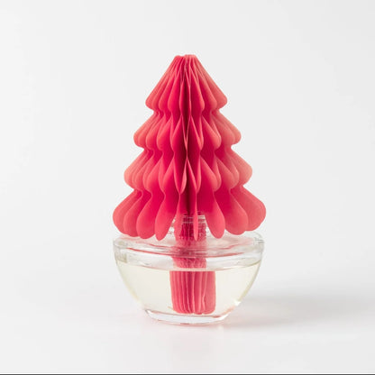 bright pink honeycomb-shaped tree sitting on a clear container filled with fragrance oil shown on a white background