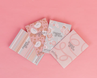 assorted Sweet Grace Scented Sachets fanned out across a pink background
