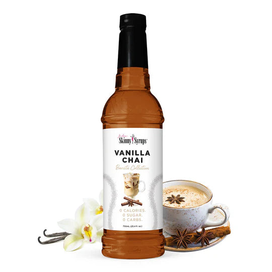 bottle of Vanilla Chai skinny syrup set next to cup of chai and spices.