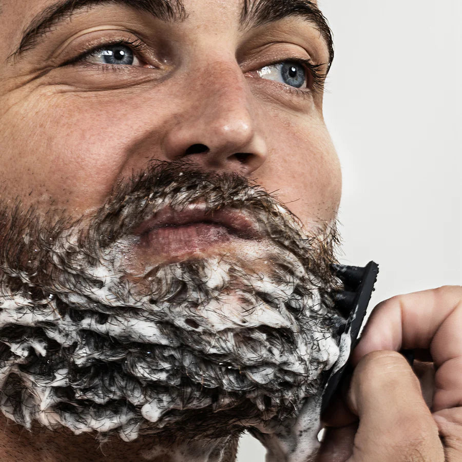 close-up of someone washing their beard.