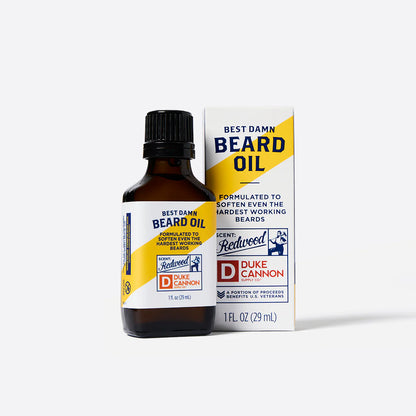 Bottle and box of Duke Cannon Best Damn Beard Oil on a white background