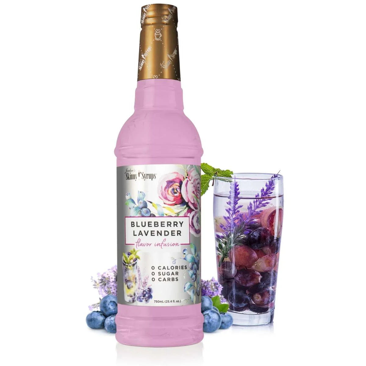 bottle blueberry lavender skinny syrup set next to a glass filled with liquid and fruit.