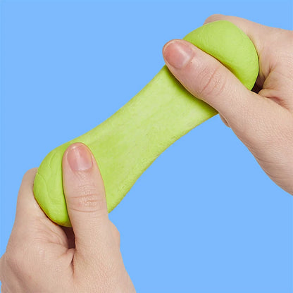 hands playing with citron colored putty shown on a bright blue background