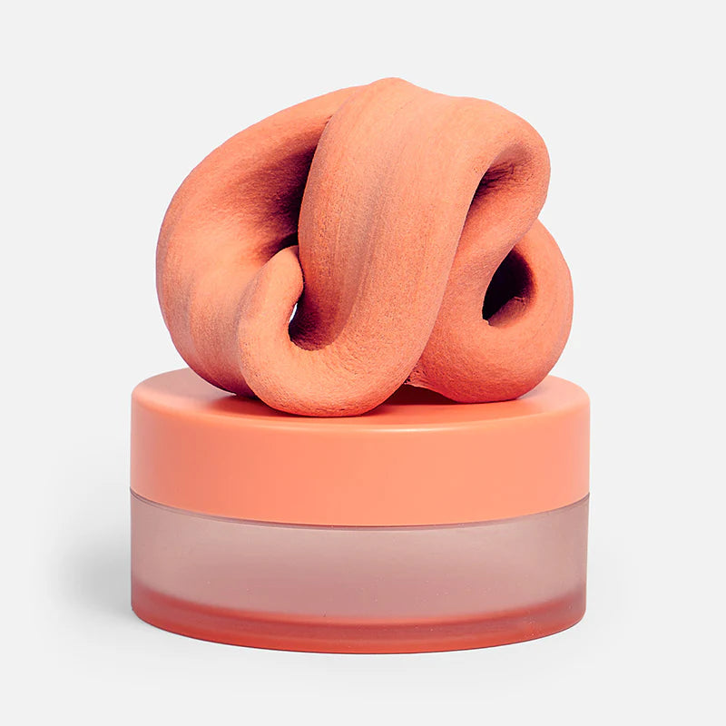 A peach-colored, textured, knotted fidget putty set against a clean white background.