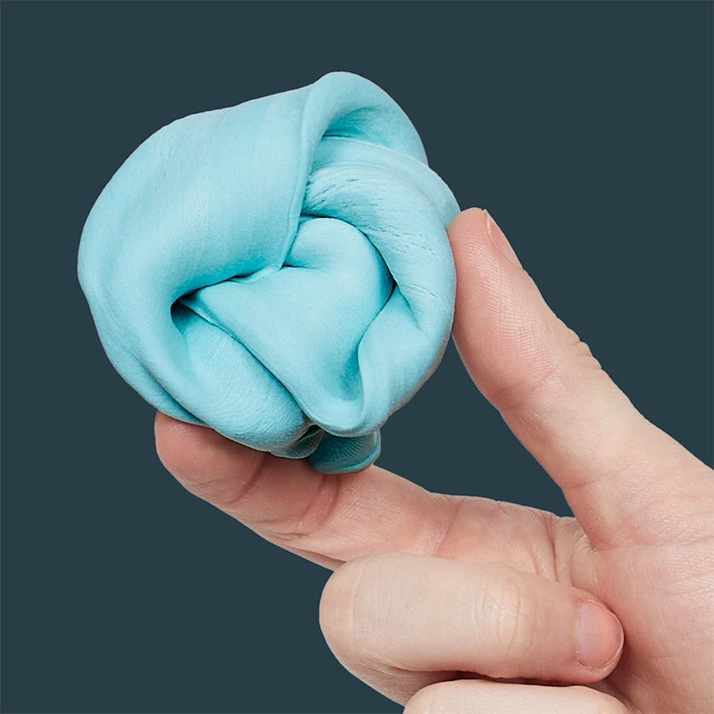 Hand holding a ball of blue fidget putty against a dark background