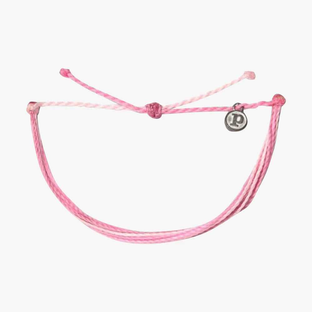 Pura Vida multi strand corded bracelet in varying shades of pink and white with a Pura Vida logo charm