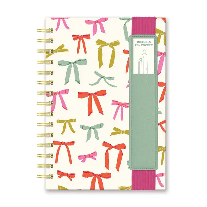 notebook with ribbon bows design printed on the cover.