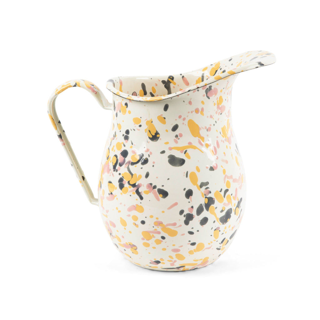 off-white enamel pitcher with splatters of yellow, pink, and grey displayed on a white background.