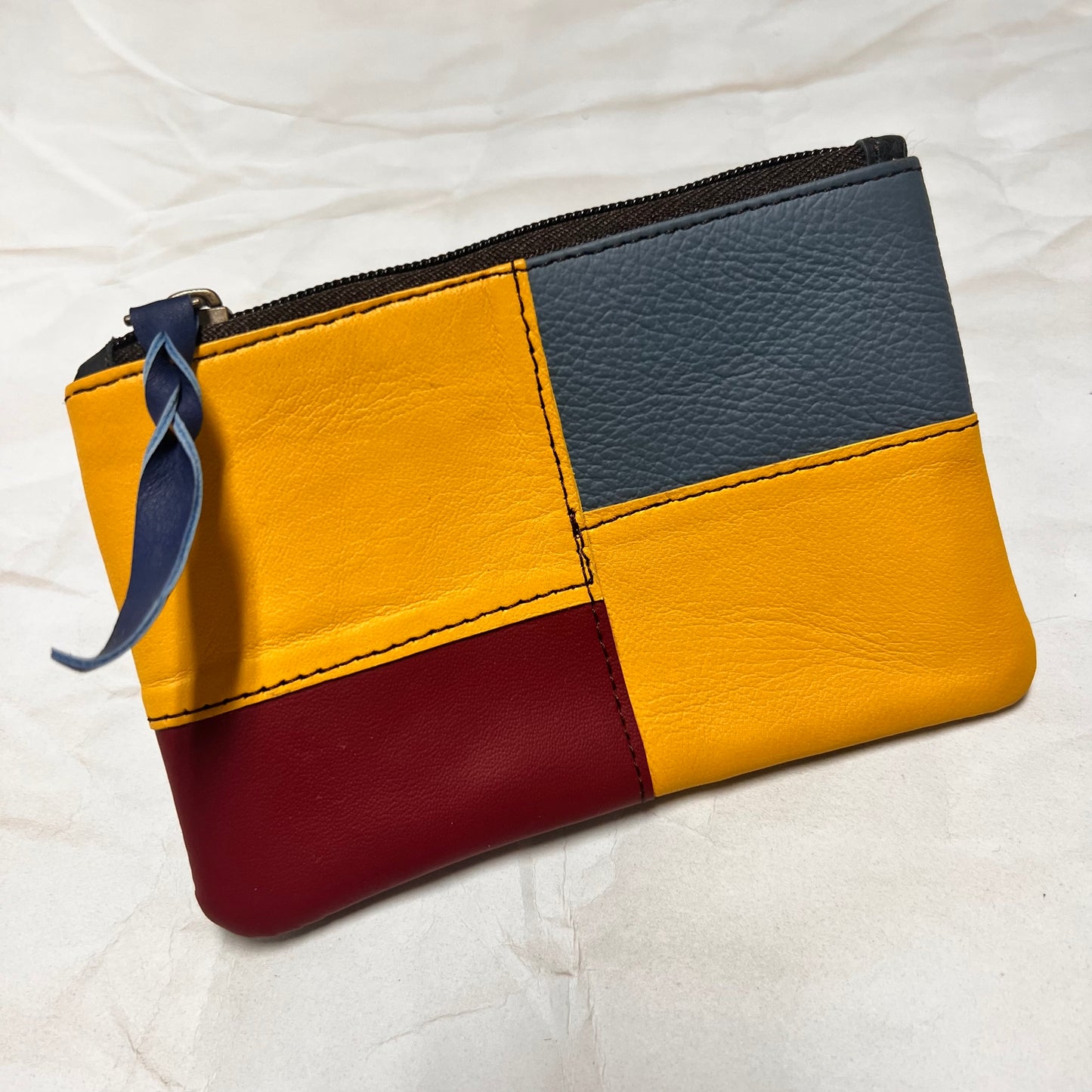 zahra pouch with yellow, blue, and burgundy patchwork.