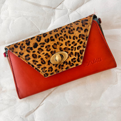 orange secret clutch wallet with cheetah print flap.