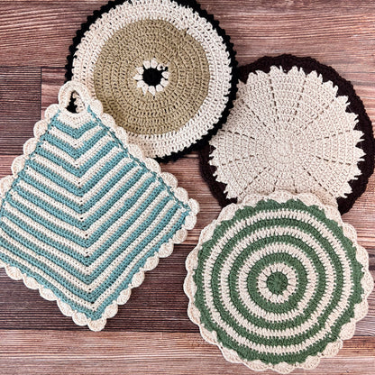 4 styles of crocheted pot holders arranged on a wooden surface.