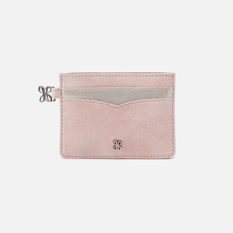 Pink cardholder with silver accents on a light gray background