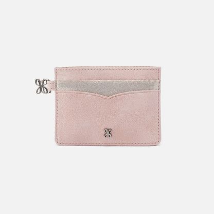 Pink cardholder with silver accents on a light gray background