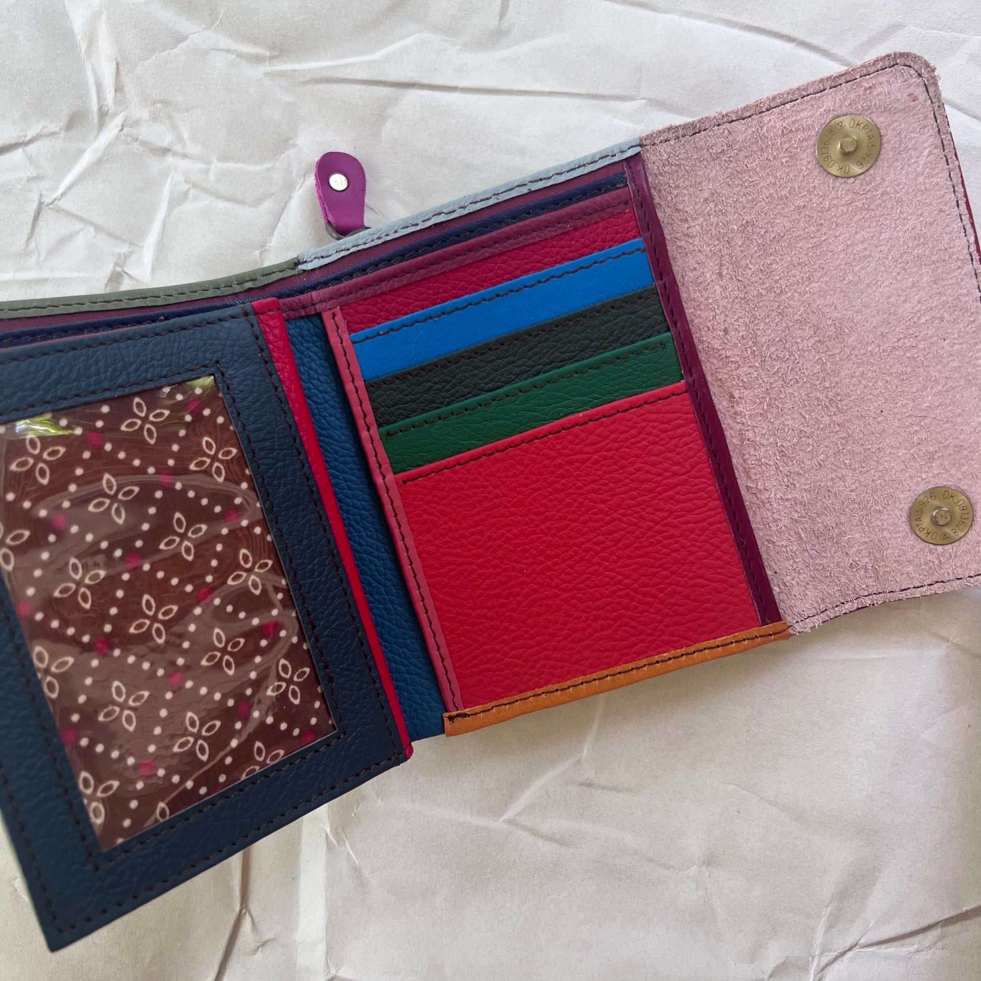 olive rings wallet laying open showing colorful card slots