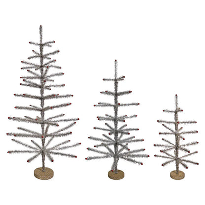 3 sizes of silver tinsel trees in a row with their branches folded out.