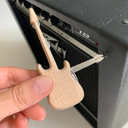 a persons hand illustrating the use of the guitar multitool on a speaker