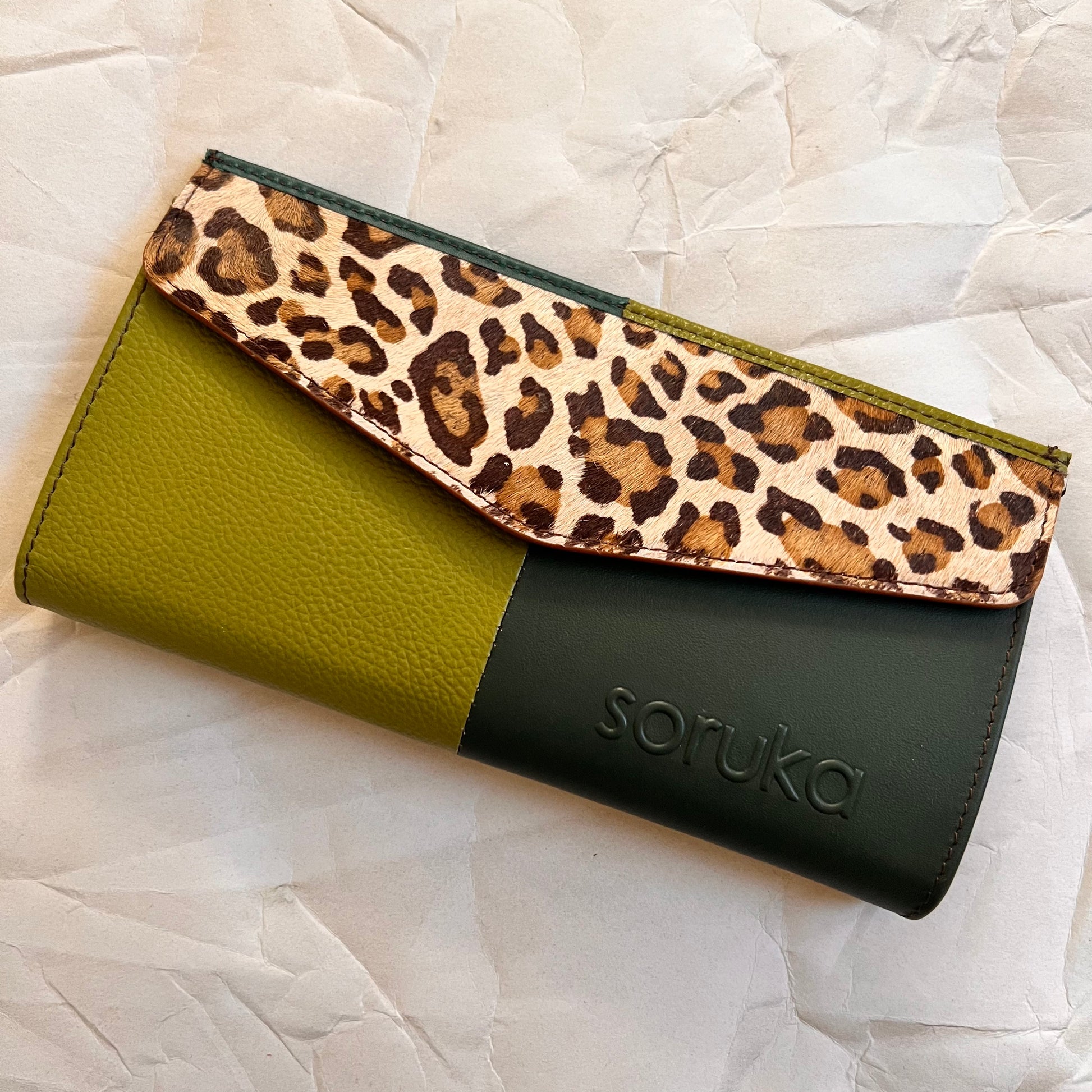 green judith wallet with animal print flap.