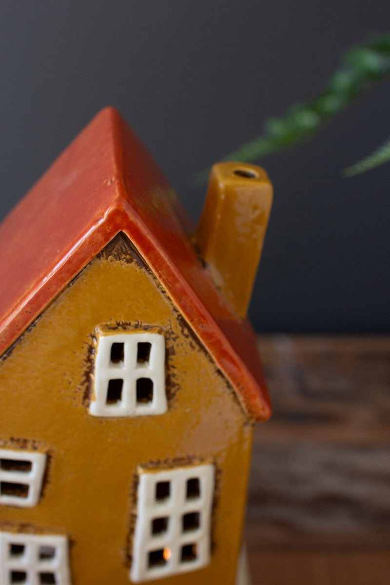 Close up of mustard yellow wonky house.