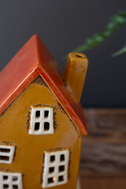 Close up of mustard yellow wonky house.