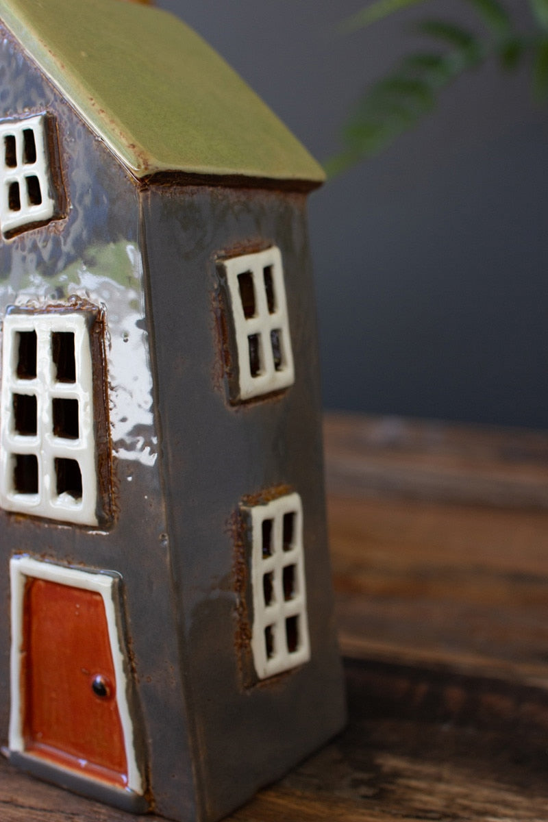 Close up of Gray and green wonky house.