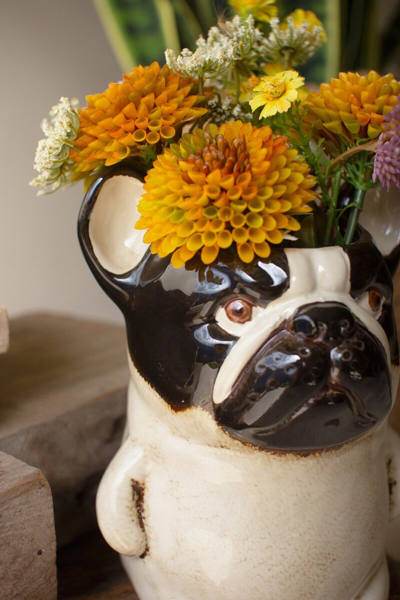 close-up of Ceramic French Bulldog Planter filled with orange flowers