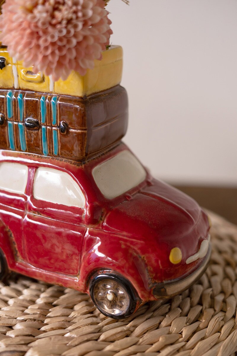 close-up of red Ceramic Car With Luggage Planter