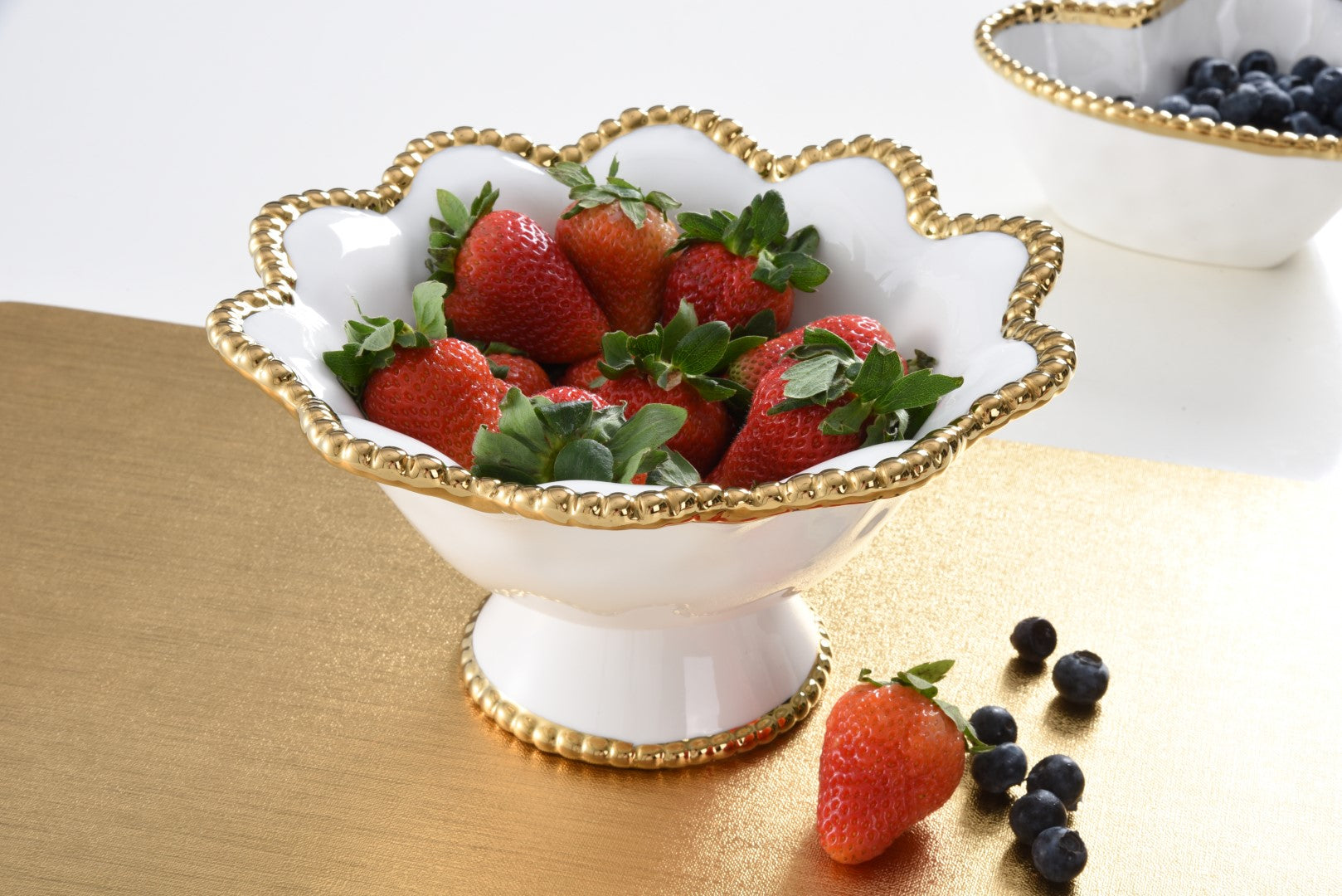 Golden Salerno Footed Bowl with strawberries in it
