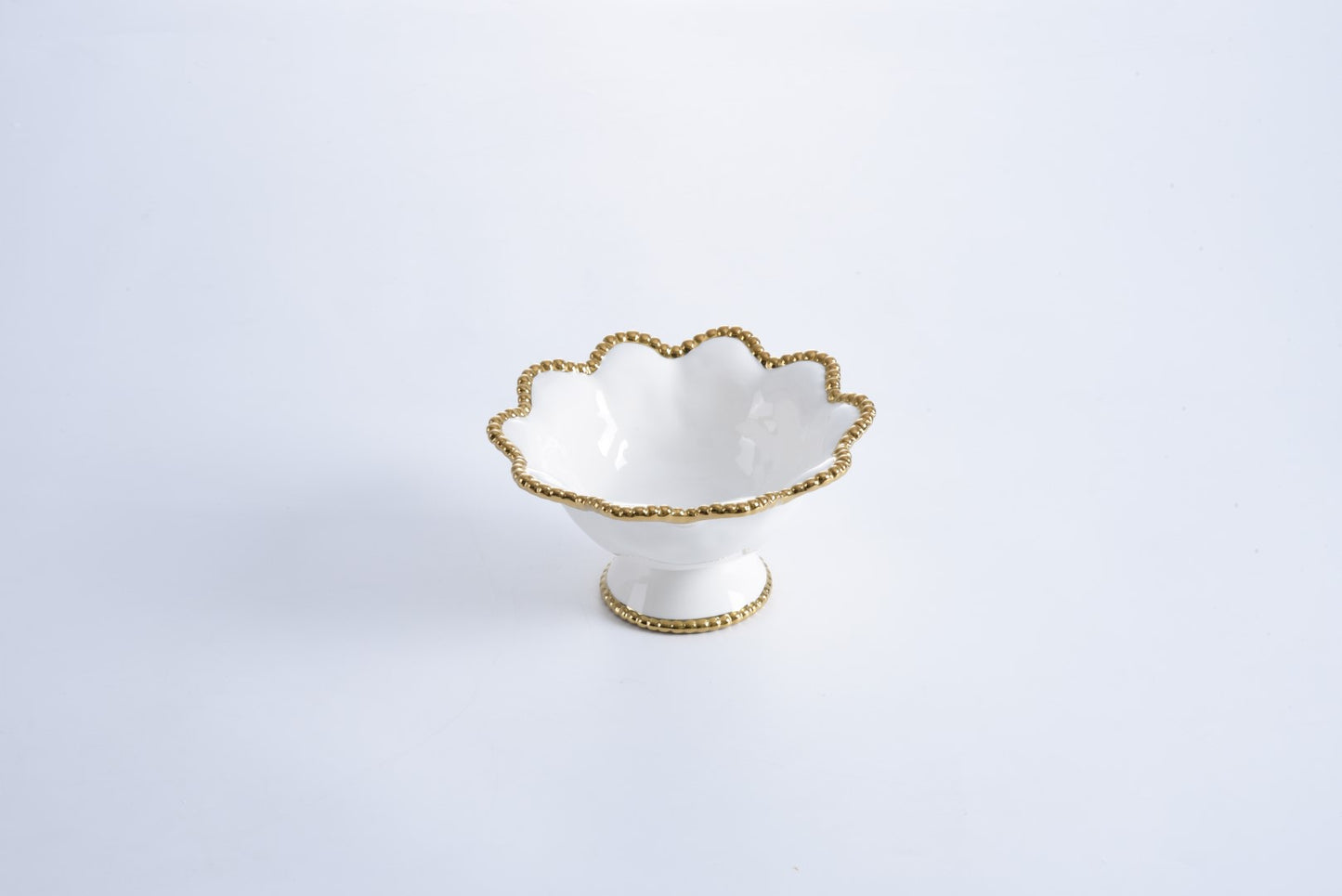 white Footed Bowl with gold beaded rim on a white background
