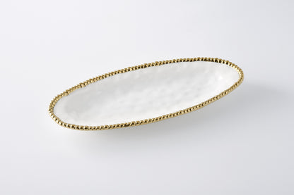 white oval serving platter with gold beaded rim shown on a white background
