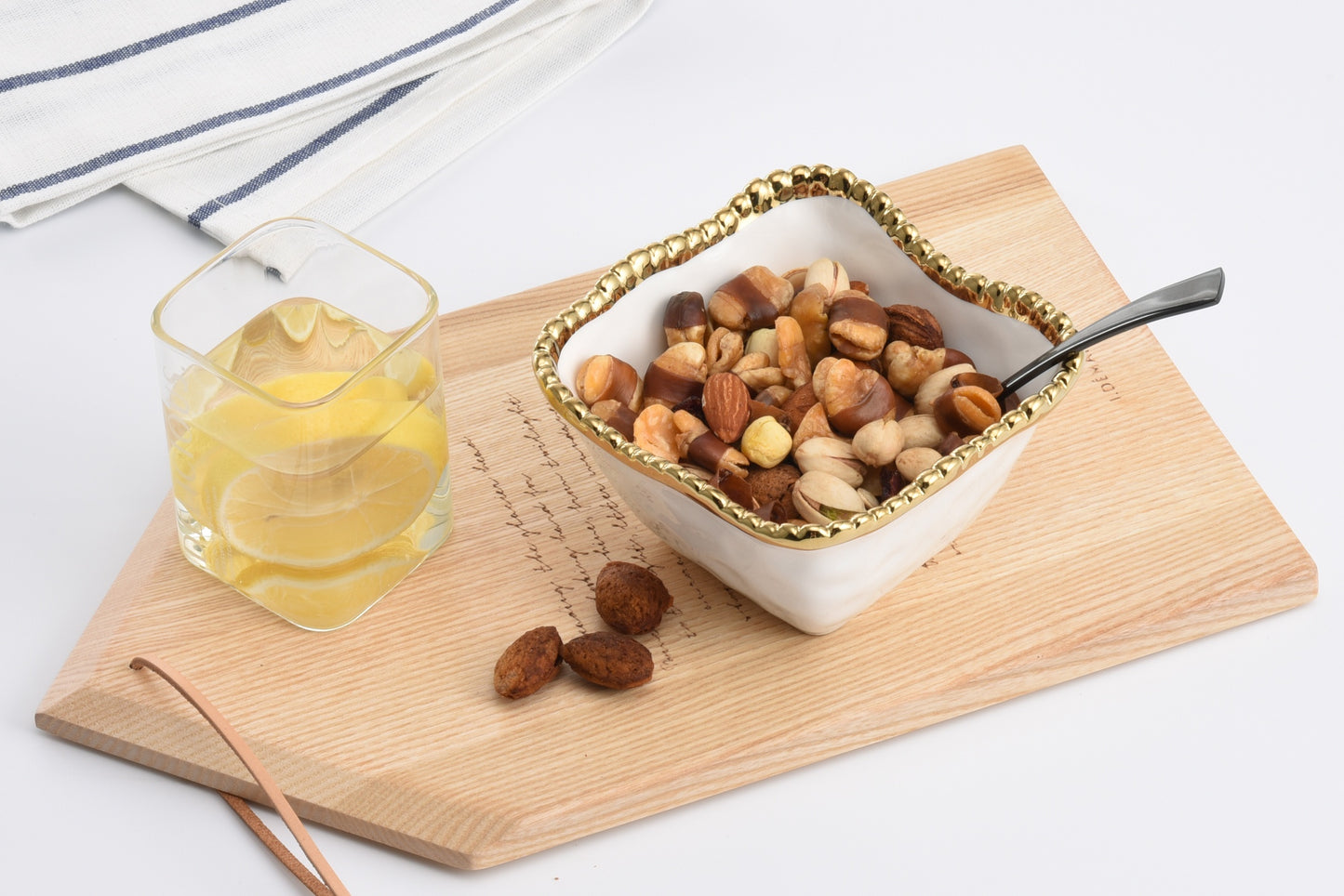 Golden Salerno Square Snack Bowl with mixed nuts in it 

