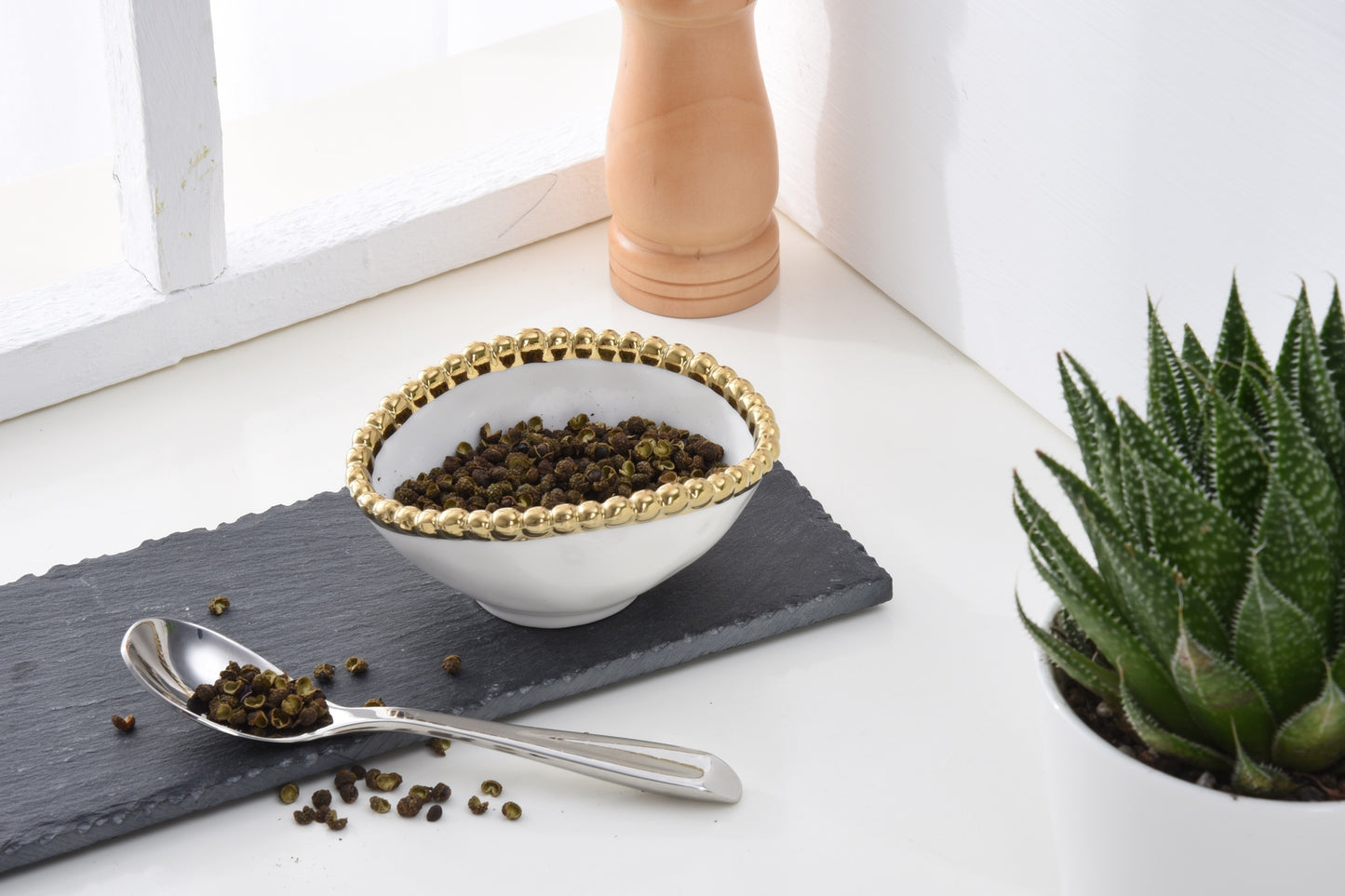 Golden Salerno Oval Condiment Bowl filled with pepper corns
