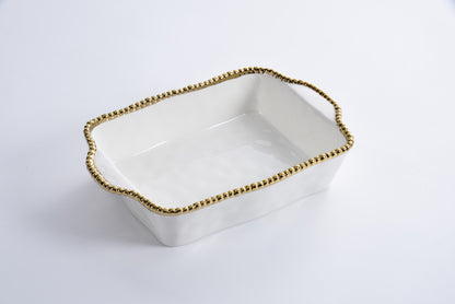 white ceramic baking dish with gold beaded rim