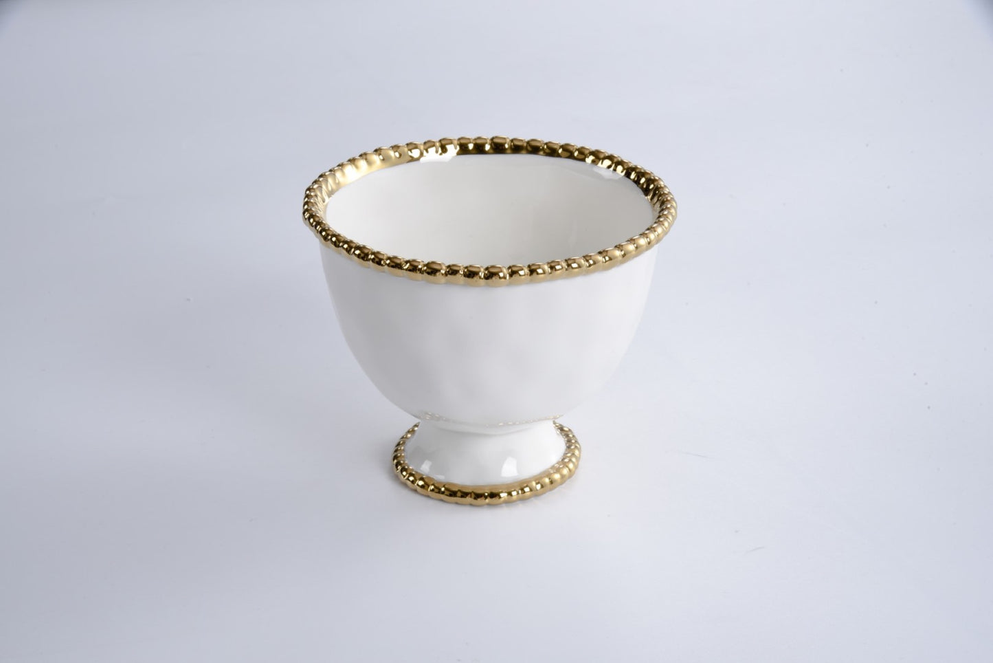 small footed bowl on a grey background
