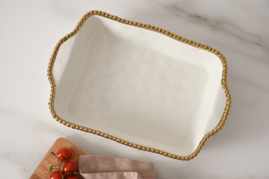 top view of white rectangle baking dish with gold beaded rim