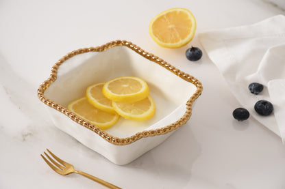 white and gold Square Mini Baker with fruit in it
