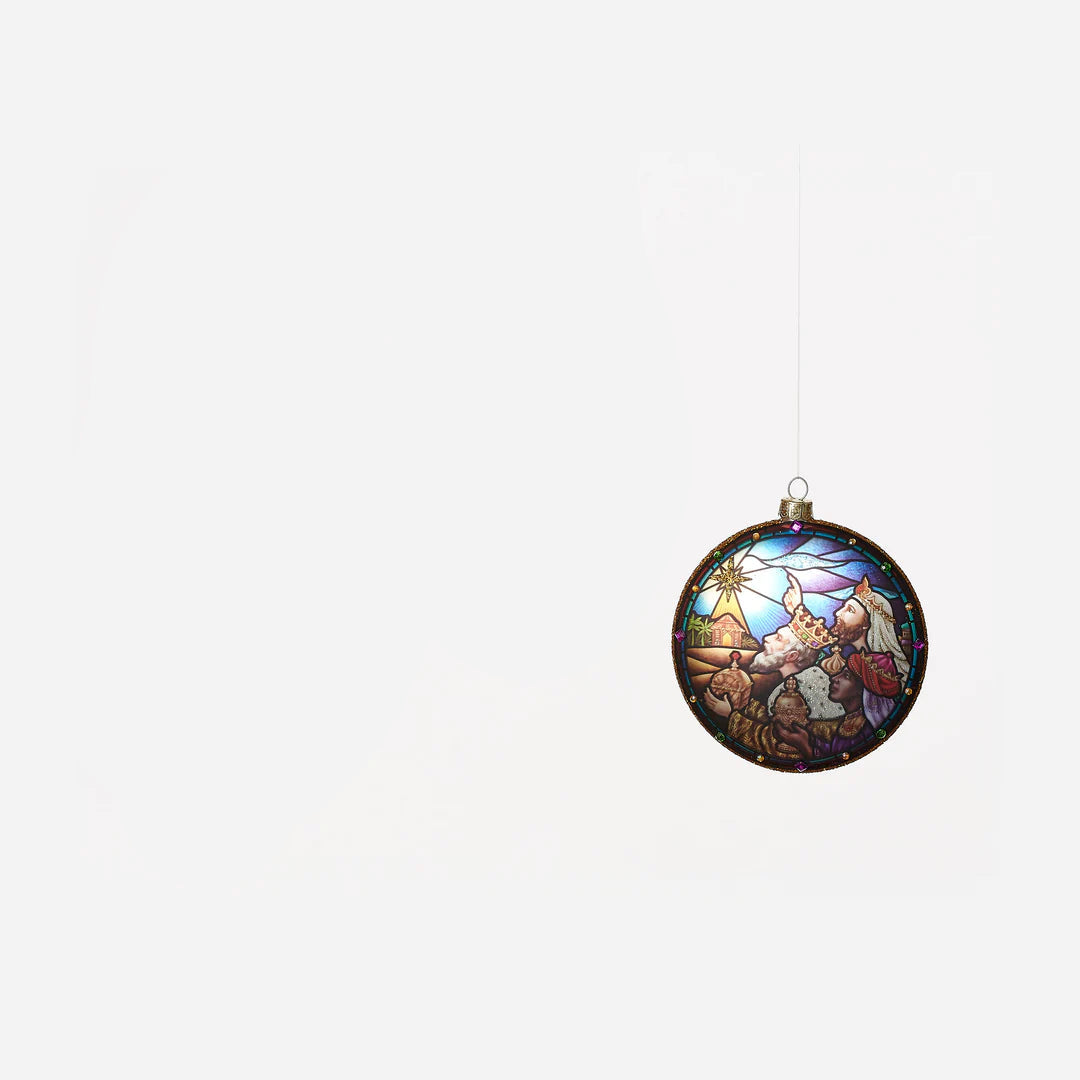 round glass ornament with image of 3 wise men on it