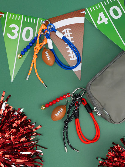 red and blue football bag charms arranged with pom poms and pennants