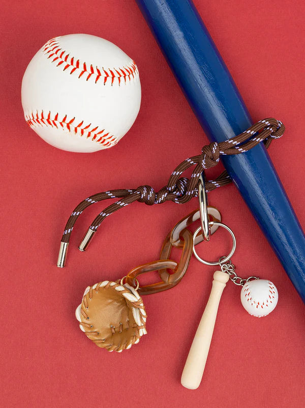 baseball bag charm arranged on a red background