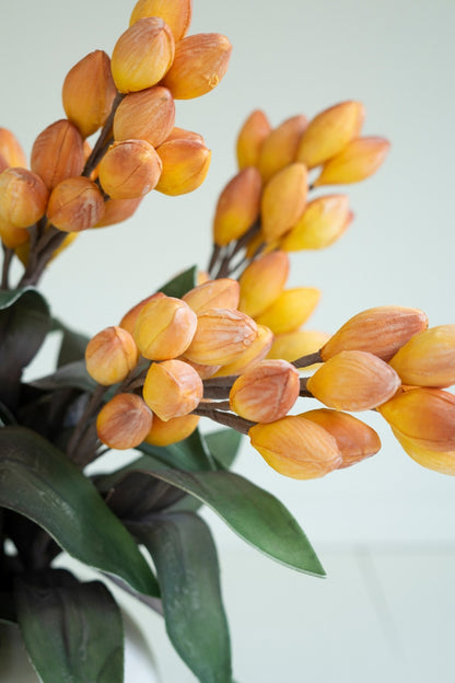 close-up of Artificial botanical stem with green leaves on a white background