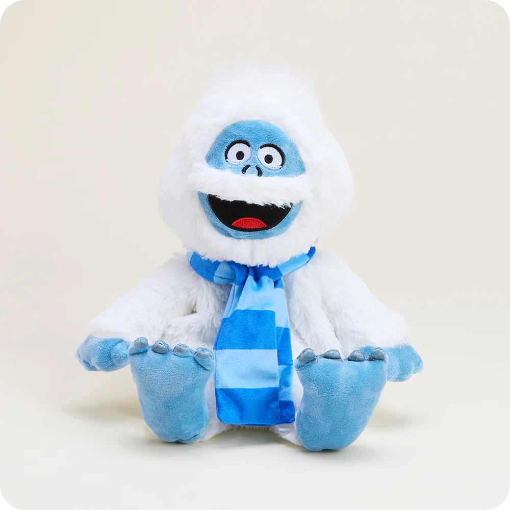 front view of Bumble Warmies who is white with blue accents and a smiling face wearing and dark blue striped scarf 