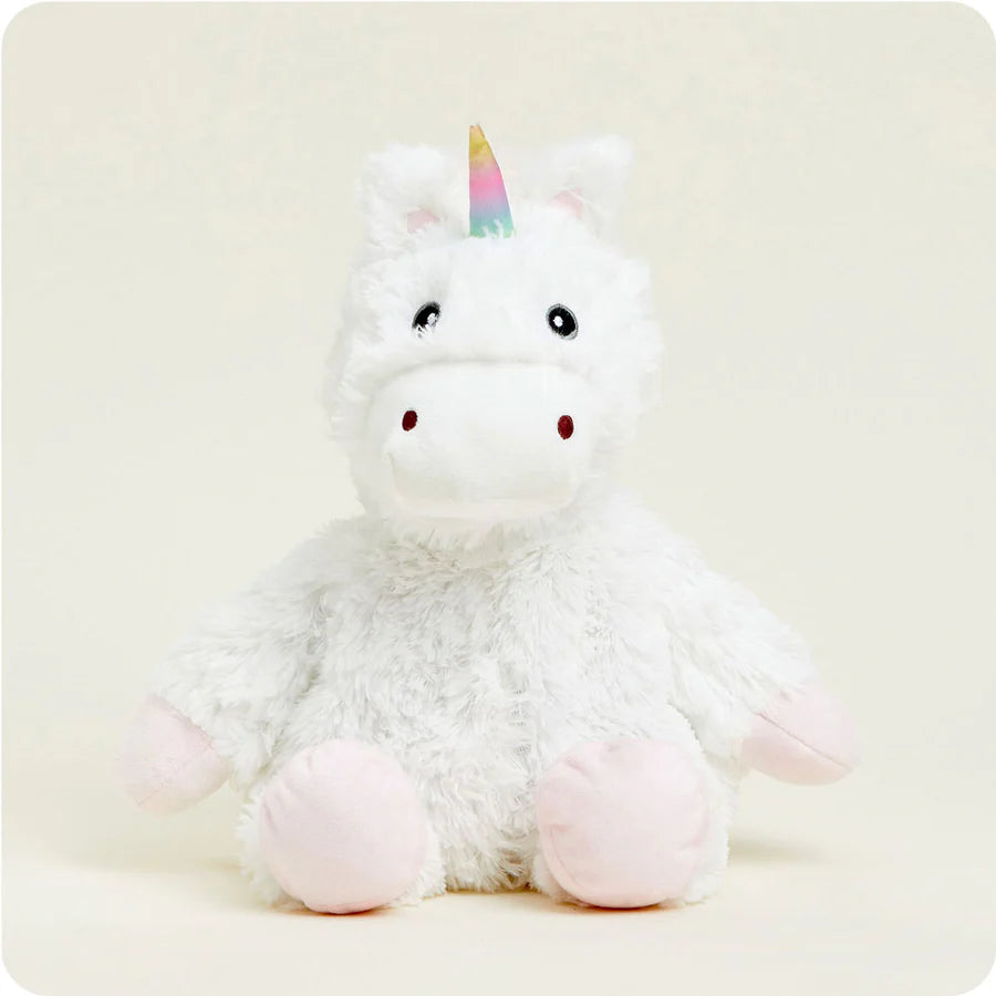 white unicorn with rainbow horn stuffed animal seated on a white background.