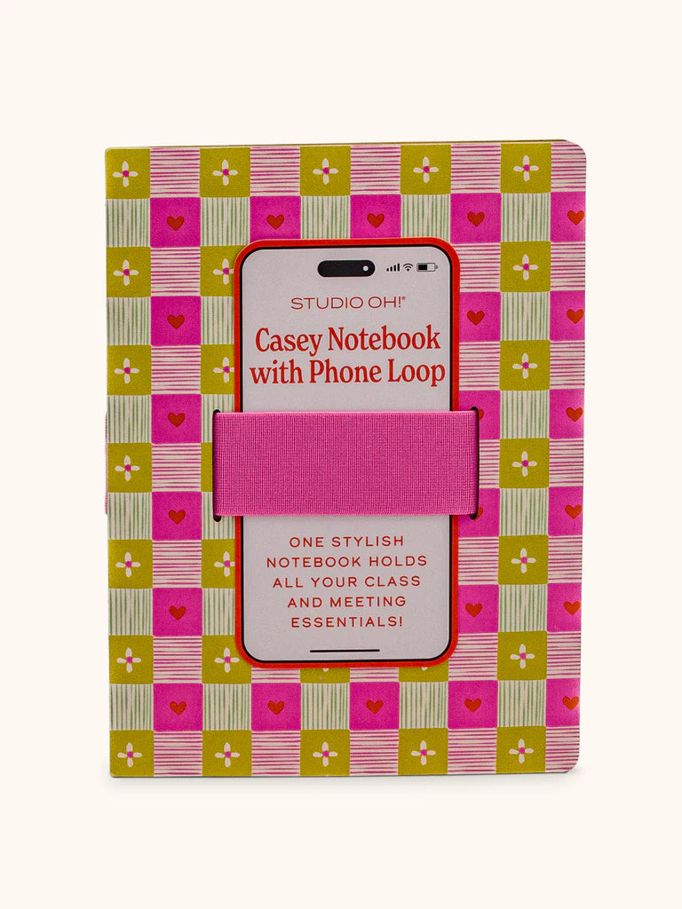 front of notebook with pink and green check pattern and hearts and flowers in the checks with a pink elastic phone band.