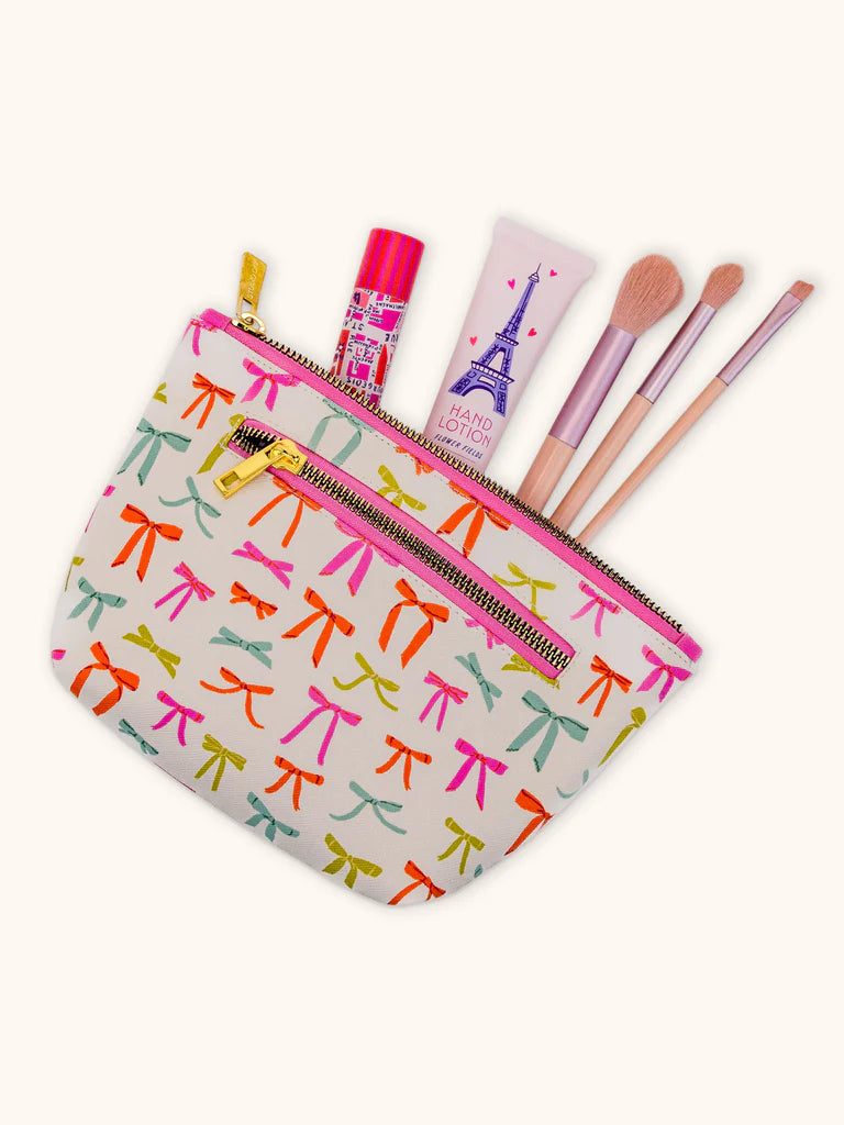 put a bow on it bag with make-up and brushes coming put of it.