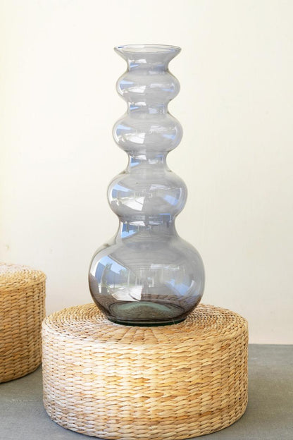 blue bubble vase on a wicker stand